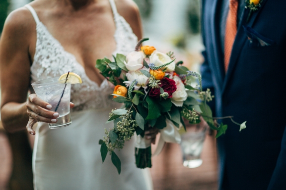 bride-holding-bouquet-and-cocktail